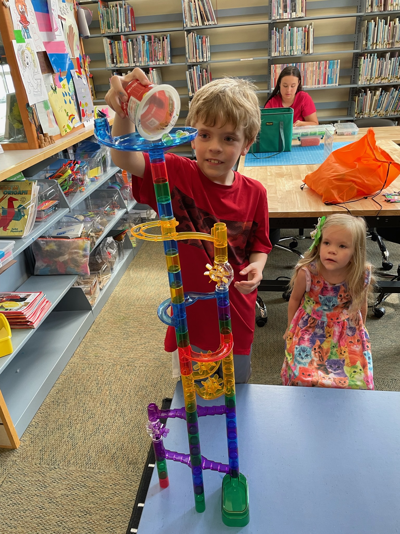 Young boy and girl creating marble tower at Derby Neck Library's Makerspace.