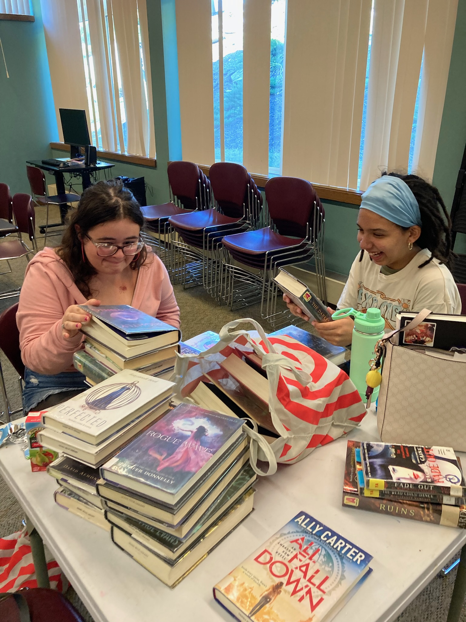Two teenagers have fun with free books.